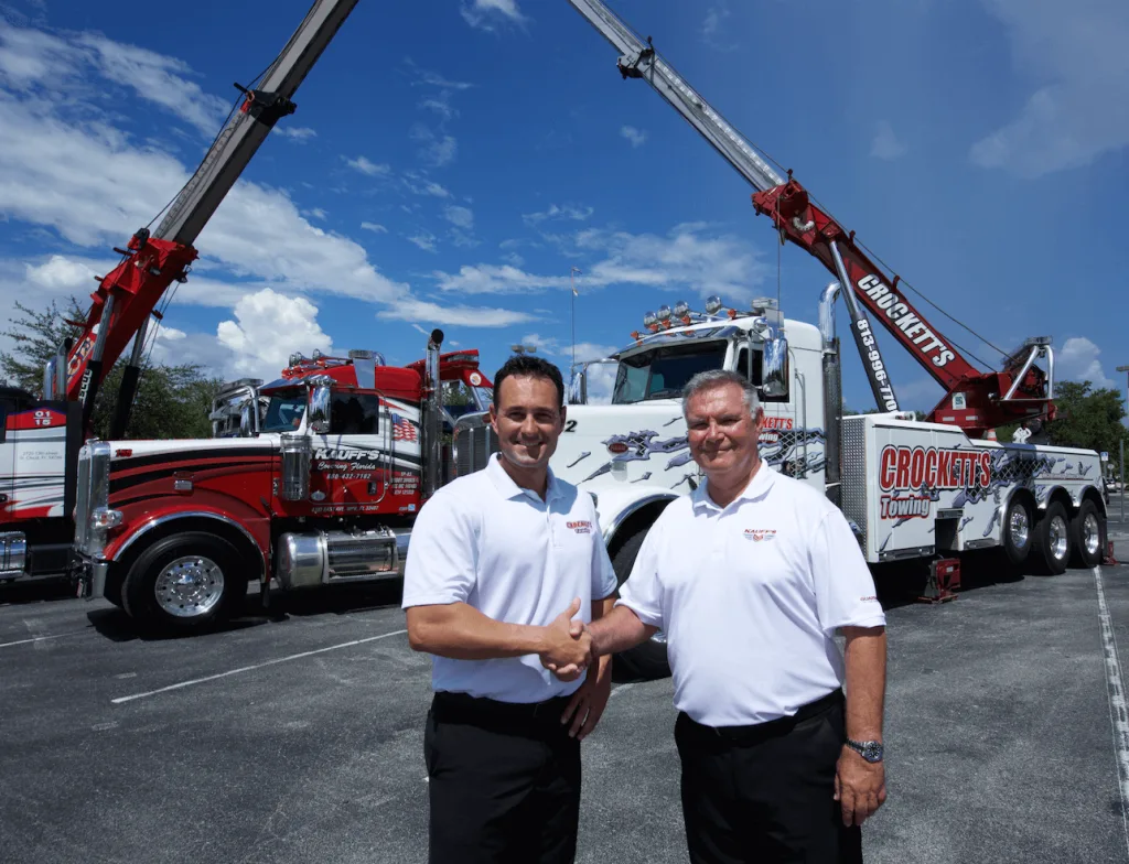 Scotty Crockett of Crockett's Towing and Geoff Russell of Kauff's Towing shaking hands, symbolizing the creation of Guardian Fleet Services