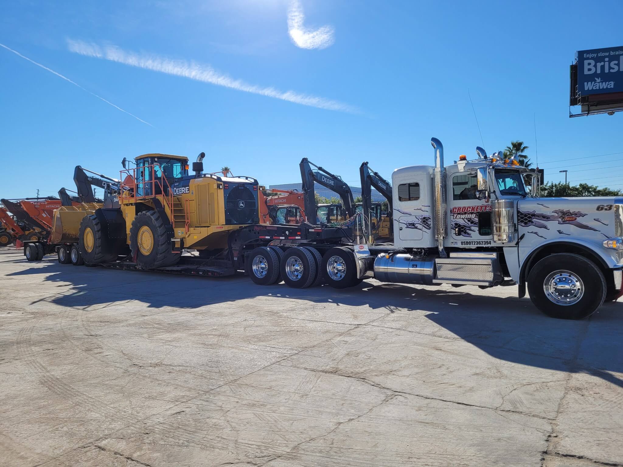 Professional truck transporting construction equipment